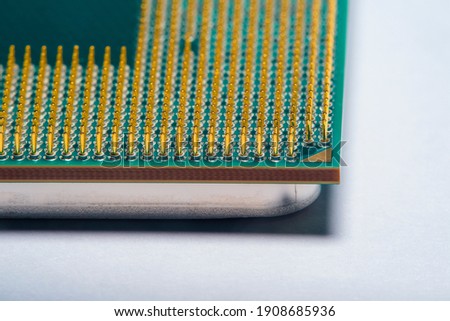 Close-up of a part of a microprocessor in soft focus under high magnification. Details of a computer component under a microscope on a light background