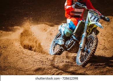 Close-up part of mountain bikes race in dirt track in sunshine day time. Concept focus of during an acceleration in action sport