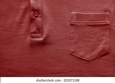 Closeup Part Of A Shirt From Cotton Fabric Of Red Color With A Big Pocket And A Fastener With The Button 