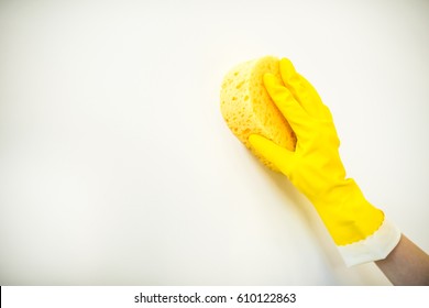 Close-up Partial View Of Hand In Rubber Glove Cleaning Wall With Sponge