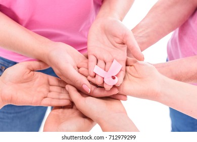 close-up partial view of women holding pink ribbon, breast cancer awareness concept - Shutterstock ID 712979299