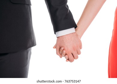 close-up partial view of young couple holding hands 