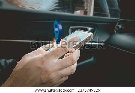 Close-up of a passenger sitting in a car using a mobile phone. Concept of viewing GPS navigation systems, sending emails