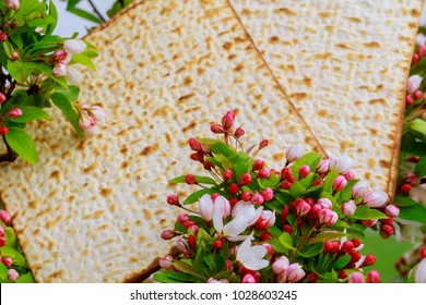 Closeup of Passover Matzah background matzoh over wooden table.