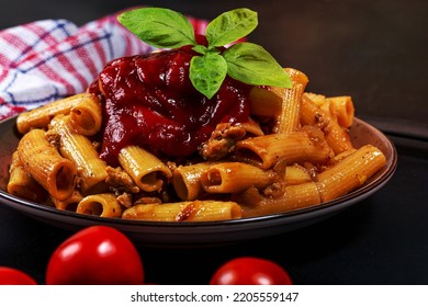 Close-up Of Pasta With Chicken, Tomato Sauce And Basil Leaves