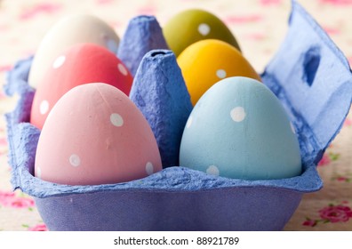 Close-up of pastel colored Easter eggs in a blue carton - Powered by Shutterstock