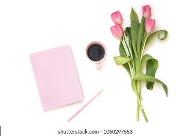 Close-up Of Pastel Pink Notebook, Pen, Coffee Cup And Tulip Flowers Bouquet Isolated On White Background. Flat Lay, Top View. Minimal Feminine Flatlay. 