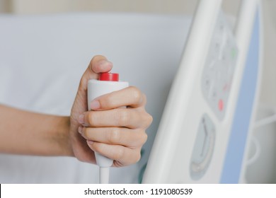 Close-up of patient hand pressing emergency button calling nurse in case of emergency in the hospital, patients need to help exigent, instant, pressing.
