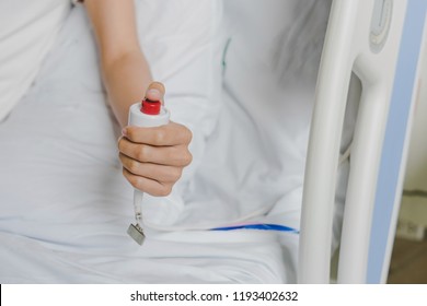 Close-up of patient hand pressing emergency button calling nurse in case of emergency in the hospital, patients need to help exigent, instant, pressing. - Shutterstock ID 1193402632