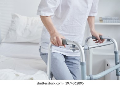 Close-up Of Patient Standing Up With The Walker From The Hospital Bed