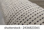 Closeup of the pattern on a carpet, white and grey checkered, detailed texture of the woven fabric, natural light, high resolution photography, macro lens, shallow depth of field, focus stacking