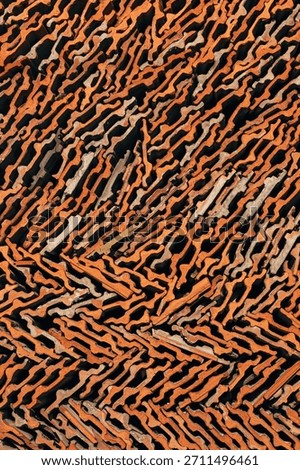 Closeup pattern of stacked old terracotta roof tiles forming an abstract geometric texture in warm earthy tones. Vertical image.