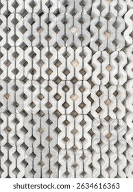 Close-up of patterned concrete blocks in a park walkway, Perfect for landscaping, urban design, and outdoor projects, above view for background.