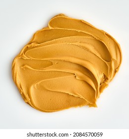 Closeup Of Peanut Butter Smear Textured On White Background. Nut Smudge Sandwich Snack Ingredient