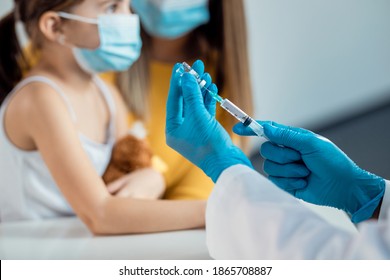 Close-up of pediatrician preparing a vaccine for a child during coronavirus pandemic.  - Powered by Shutterstock