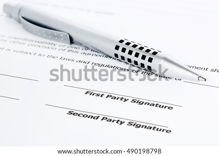 closeup of a pen on an unsigned contract