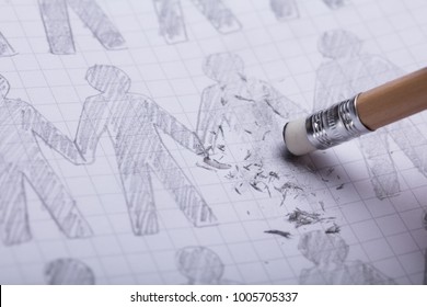 Close-up Of Pencil Eraser Erasing Drawn Figures On Paper