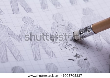 Close-up Of Pencil Eraser Erasing Drawn Figures On Paper