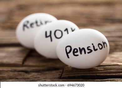 Closeup of pension  401K and retire written on white eggs - Shutterstock ID 694673020