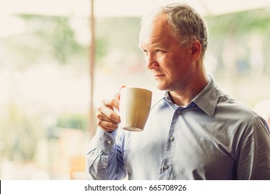 Closeup of Pensive Middle-aged Man Drinking Tea - Powered by Shutterstock