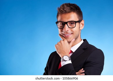 Closeup Of A Pensive Young Business Man On Blue Background