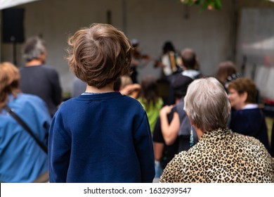 Closeup Of People Enjoying And Listening Music While Artist Playing Musical Instruments During Event In City At World And Word Spoken Festival