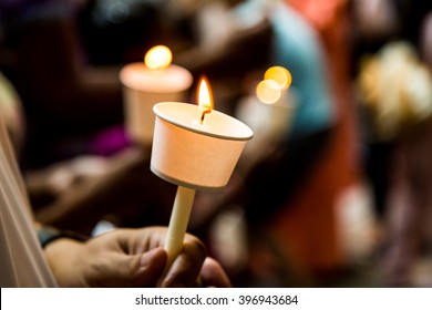 Closeup Of People Holding Candle Vigil In Darkness Expressing And Seeking Hope