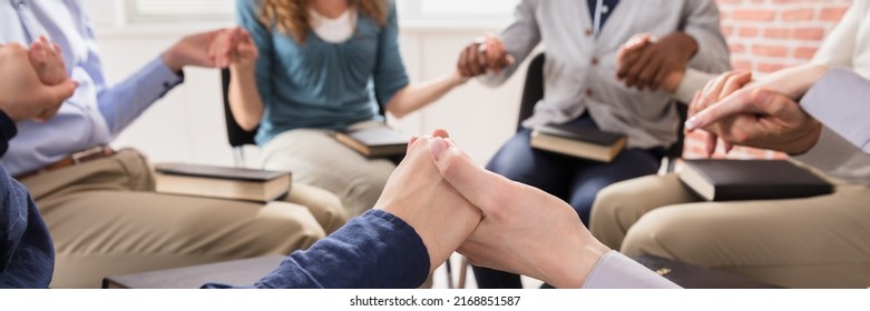 Close-up Of People Holding Each Others Hand Praying Together