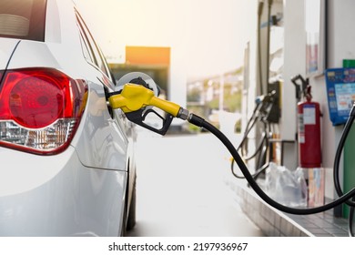 Closeup of people pumping gasoline fuel in car at gas station. Petrol or gasoline being pumped into a motor vehicle car.  - Shutterstock ID 2197936967