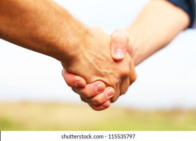 Closeup of people shaking hands - Shutterstock ID 115535797