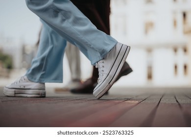 Close-up of people walking in casual shoes on an urban street, highlighting the movement and energy of city life. - Powered by Shutterstock