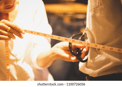 closeup of people,Asia woman,girl doing Waist measurement at the tailor,dressmaker shop.