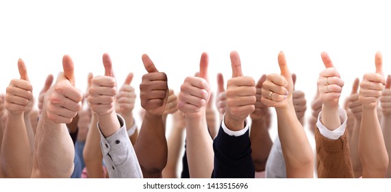 Close-up Of People's Hand Showing Thumb Up Sign Against Isolated On White  Background