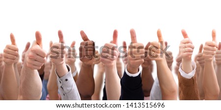 Close-up Of People's Hand Showing Thumb Up Sign Against Isolated On White  Background