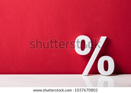 Close-up Of A Percentage Sign Leaning On Red Wall