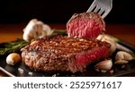 Close-up of a perfectly cooked medium-rare steak with a fork lifting a slice to reveal its juicy interior. The steak is surrounded by garlic cloves and rosemary sprigs.