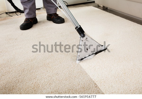 Close-up\
Of A Person Cleaning Carpet With Vacuum\
Cleaner