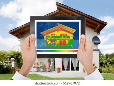 Close-up Of The Person Detecting Heat Loss Outside The House Using Digital Tablet