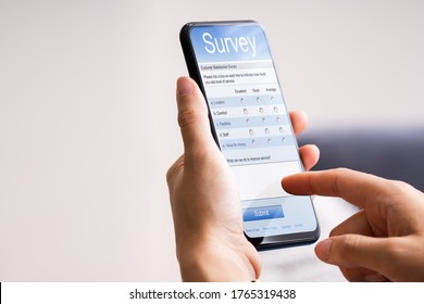 Close-up Of Person Filling Online Survey Form On Mobile Phone