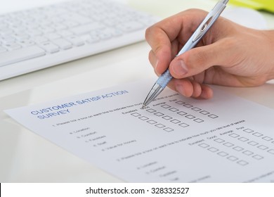 Close-up Of Person Hands Filling Survey Form With Pen - Shutterstock ID 328332527