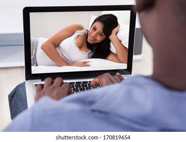 Close-up Of Person Having Video Chat With Woman On Laptop