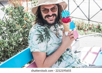 Close-up Of A Person Holding An Ice Cream. Man Eating Ice Cream Very Happy Holds It In His Hand. Smiling Male On Vacation Skipping Diet By Eating Carbs