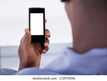 Close-up Of Person Holding Mobile Phone In Hand