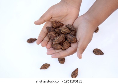 A Closeup Of A Person Holding A Pile Of Harad Against A White Background