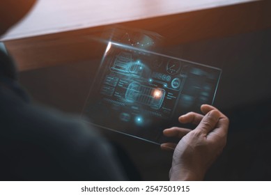 Close-up of a person holding a transparent digital interface displaying car diagnostics, futuristic technology, and innovative software concepts.  
