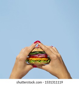 Close-up person holding a yummy veggie burger - Powered by Shutterstock