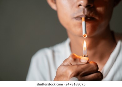 Close-up of a person lighting a cigarette with a lighter. - Powered by Shutterstock