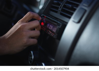 A Closeup Of A Person Listening To Radio While Driving His Car