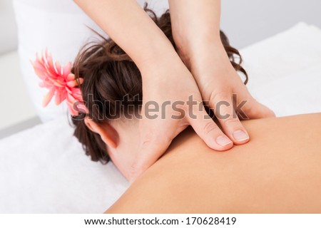 Close-up Of A Person Receiving Shiatsu Treatment From Massager