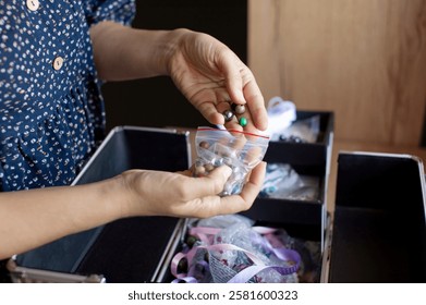 Close-up of a person selecting beads from a variety, focusing on creativity and the art of handcrafting